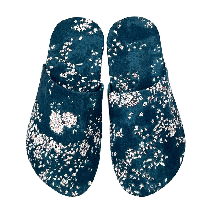 whisper slippers sewing pattern by dhurata davies, made in a small white floral pattern on a blue background